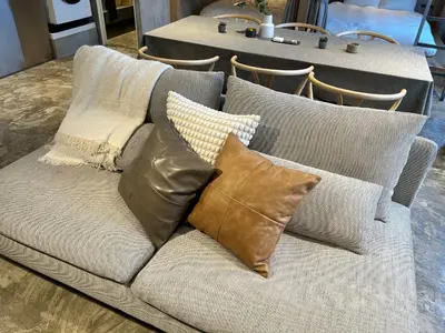 a couch with pillows on it with a table at Spacious Tokyo Base near Tamachi station Hotel Ten Tamachi in Tokyo