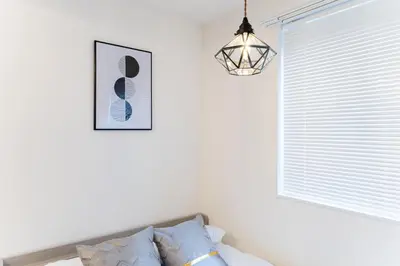 a living room with a pendant light and a couch at #1 -\u9ad8\u7530\u99ac\u5834\u30a2\u30cd\u30c3\u30af\u30b9- Condo in Tokyo