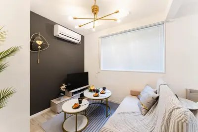 a living room with a couch and a table at #1 -\u9ad8\u7530\u99ac\u5834\u30a2\u30cd\u30c3\u30af\u30b9- Condo in Tokyo