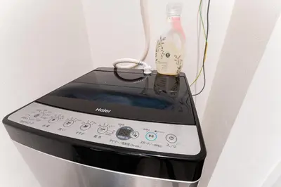 a cell phone is plugged into a wall at #1 -\u9ad8\u7530\u99ac\u5834\u30a2\u30cd\u30c3\u30af\u30b9- Condo in Tokyo