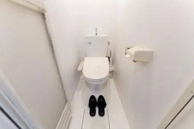a bathroom with a toilet and a pair of shoes at #1 -\u9ad8\u7530\u99ac\u5834\u30a2\u30cd\u30c3\u30af\u30b9- Condo in Tokyo