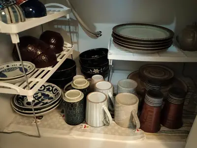 a pantry filled with plates and bowls and dishes at \u6e90\u6c0f\u6c11\u5bbf in Tokyo