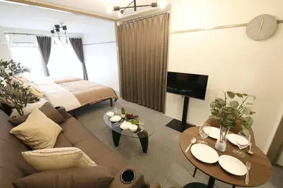 a living room with a couch and a table at \u30aa\u30b0\u30e9\u30d3\u30eb 205 in Tokyo