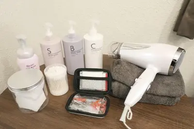 a hair dryer and other products on a table at \u30aa\u30b0\u30e9\u30d3\u30eb 205 in Tokyo