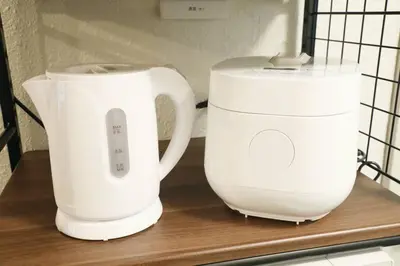 two white appliances sitting on a wooden shelf at \u30aa\u30b0\u30e9\u30d3\u30eb 205 in Tokyo