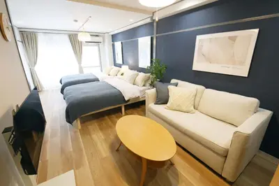 a living room with a couch and a bed at \u30aa\u30b0\u30e9\u30d3\u30eb 403 in Tokyo