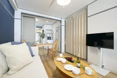 a living room with a couch and a table at \u30aa\u30b0\u30e9\u30d3\u30eb 403 in Tokyo