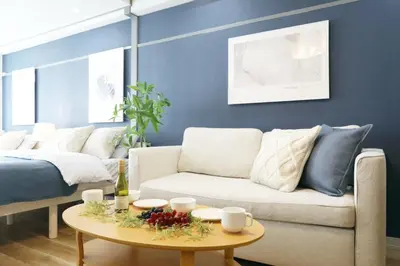 a living room with a couch and a table at \u30aa\u30b0\u30e9\u30d3\u30eb 403 in Tokyo