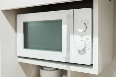 a microwave oven with its door open on a shelf at Kiwami Hotel Shinjuku in Tokyo