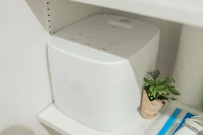 a white printer in a refrigerator with a plant at Kiwami Hotel Shinjuku in Tokyo