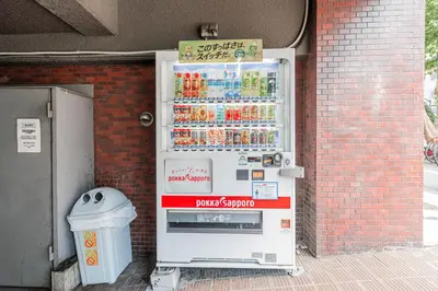 a vending machine with drinks on the side of a building at Kiwami Hotel Shinjuku in Tokyo