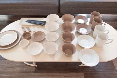 a coffee table with white cups and plates on it at Blossom House Akasaka301 in Tokyo