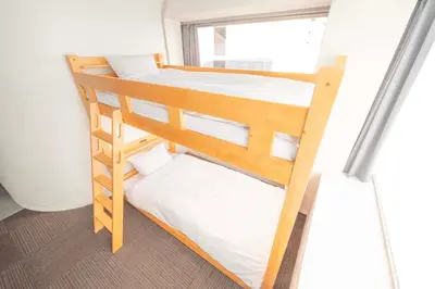 two bunk beds in a room with a window at Blossom House Akasaka301 in Tokyo