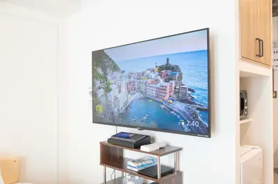 a flat screen tv hanging on a wall in a living room at Blossom House Akasaka301 in Tokyo