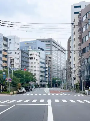 an empty street in a city with tall buildings at \u6771\u4eac\u30ea\u30ea\u30a2\u30eb\u30db\u30c6\u30eb0501 in Tokyo