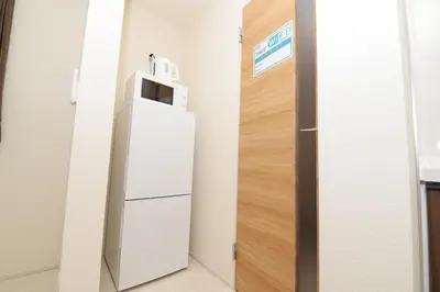 a refrigerator in a room next to a door at NYHotel 2 \u65b0\u5bbf2\u968e\u5efa\u30663\u5ba41\u30d0\u30b9\u30eb\u30fc\u30e01\u30b7\u30e3\u30ef\u30fc2\u30c8\u30a4\u30ec in Tokyo