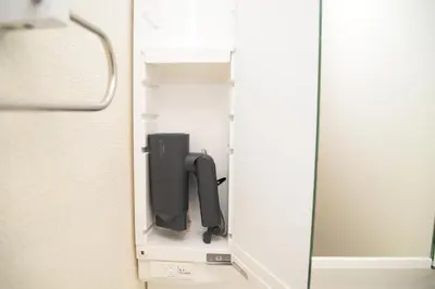 a hair dryer in a closet with a mirror at NYHotel 2 \u65b0\u5bbf2\u968e\u5efa\u30663\u5ba41\u30d0\u30b9\u30eb\u30fc\u30e01\u30b7\u30e3\u30ef\u30fc2\u30c8\u30a4\u30ec in Tokyo