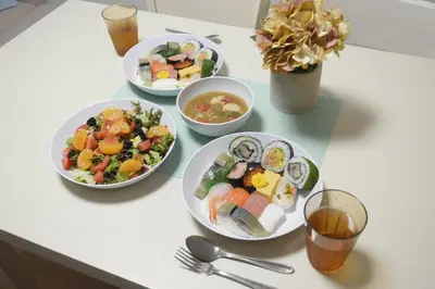 a table with four plates of food on it at Rooftop Haven \u65b0\u5c0f\u5ca9 in Tokyo