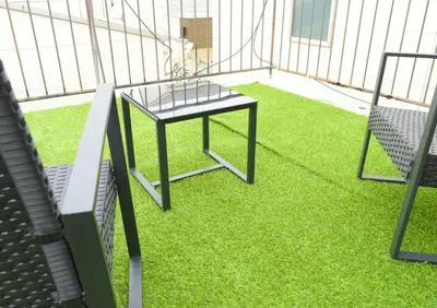 a small table on the side of a baseball field at Rooftop Haven \u65b0\u5c0f\u5ca9 in Tokyo