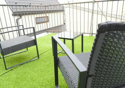 a batting cage with two chairs and a bench at Rooftop Haven \u65b0\u5c0f\u5ca9 in Tokyo