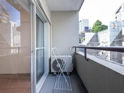 a balcony with an air conditioner and a window at Tokyo Stay Akasaka in Tokyo