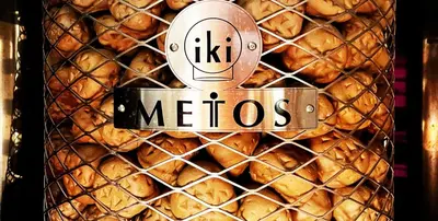 a sign that says meos in front of a pile of food at Capsule Inn Otsuka in Tokyo