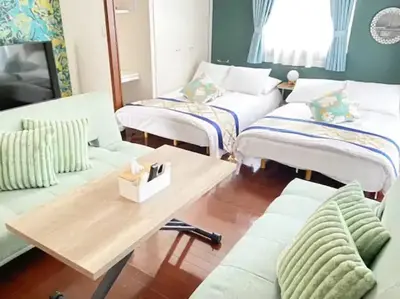 a living room with white couches and a wooden table at \u30ec\u30ac\u30ea\u30a2\u30d2\u30eb\u30ba402 in Tokyo