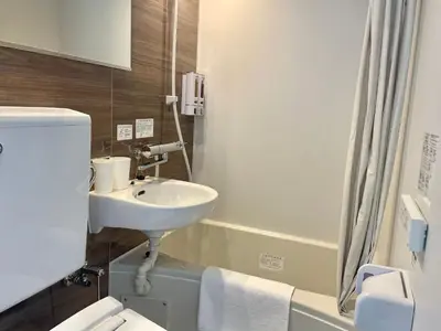 a bathroom with a sink and a toilet at Softlight Inn Asakusa Tokyo in Tokyo