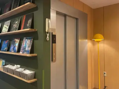 a room with a book shelf and a door at Softlight Inn Asakusa Tokyo in Tokyo
