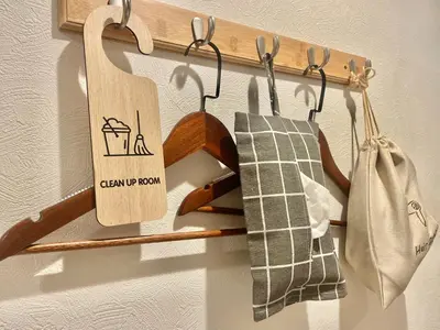 a wooden rack with towels and a sign that says cleaning up room at Softlight Inn Asakusa Tokyo in Tokyo