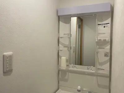 a bathroom with a mirror and a sink at Softlight Inn Asakusa Tokyo in Tokyo