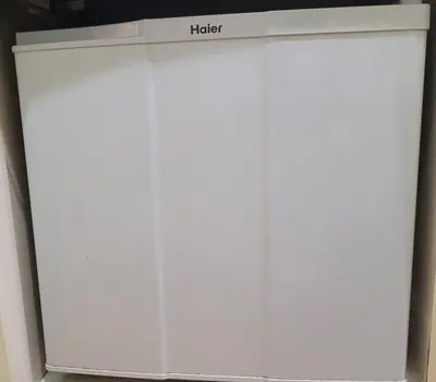 a white refrigerator with a clock on top of it at Urban Stage Okubo in Tokyo