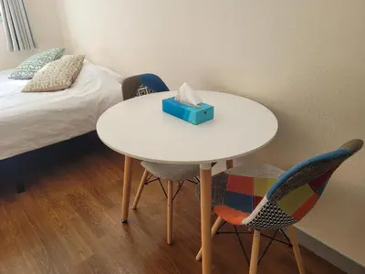 a white table with two chairs and a blue box on it at Urban Stage Okubo in Tokyo