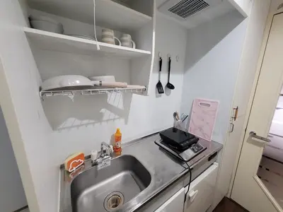 a small kitchen with a sink and a counter at Urban Stage Okubo in Tokyo