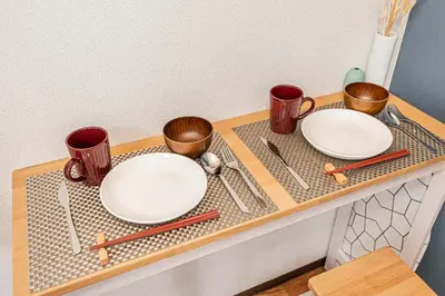 two white plates and utensils on a table at \u65b0\u5bbf\u533a\u6b4c\u821e\u4f0e\u753a\u4f0a\u52bf\u4e39\u5f92\u6b653\u5206\u949f#6 in Tokyo
