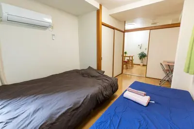 a bedroom with two beds and a table in a room at Minimalism Hotel Sumida 1 in Tokyo