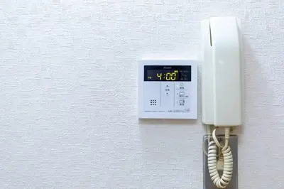 a white phone hanging on a wall at Minimalism Hotel Sumida 1 in Tokyo