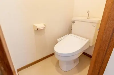 a bathroom with a toilet and a roll of toilet paper at Minimalism Hotel Sumida 1 in Tokyo