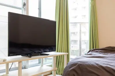 a flat screen tv sitting on a table next to a bed at Minimalism Hotel Sumida 1 in Tokyo