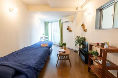 a bedroom with a bed and a table and a television at Minimalism Hotel Sumida 2 in Tokyo