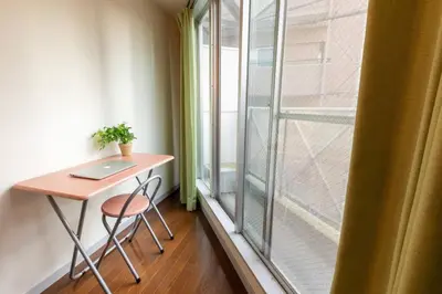 a small table with a laptop on it next to a window at Minimalism Hotel Sumida 2 in Tokyo