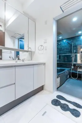a white bathroom with a sink and a shower at Hotel Beswe in Tokyo