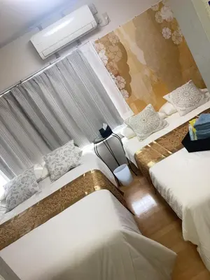 a hotel room with two beds and a window at B&K Numabukuro in Tokyo