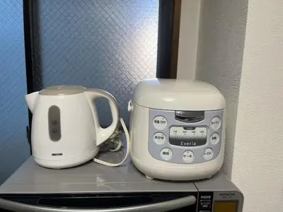 a coffee maker and a toaster on top of a microwave at Tokyo Stay Nishishinjuku in Tokyo