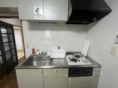 a kitchen with a sink and a stove top oven at Tokyo Stay Nishishinjuku in Tokyo