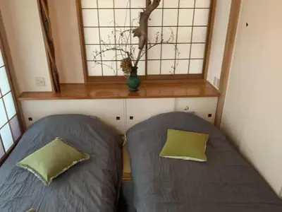 two beds in a small room with a window at Tokyo Stay Nishishinjuku in Tokyo
