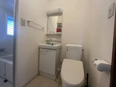a white bathroom with a toilet and a sink at Tokyo Stay Nishishinjuku in Tokyo