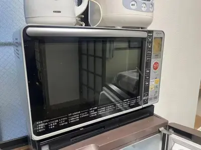a microwave with a toaster on top of it at Tokyo Stay Nishishinjuku in Tokyo