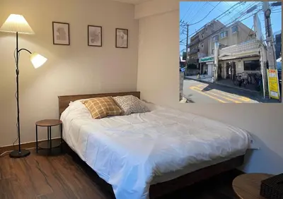 a bedroom with a bed and a lamp and a street at JK House in Tokyo