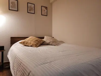 a bedroom with a bed with two pillows on it at JK House in Tokyo